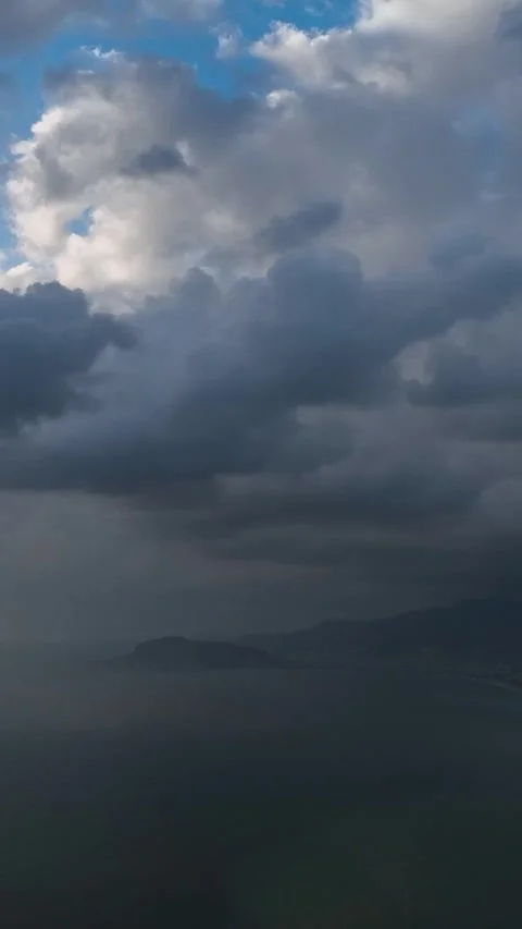 Vertical Video: Beautiful Cloudy Sky Over the Ocean with Textured Waves and Stock Footage 297725792