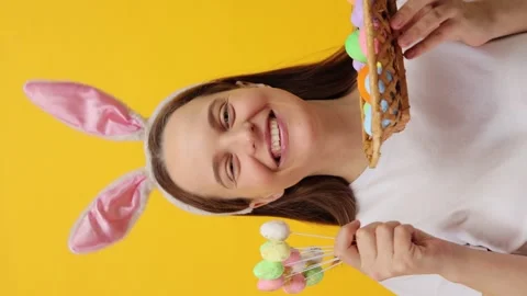 Vertical video. Beautiful happy young adult woman wearing bunny ears headband Vidéo 293243067