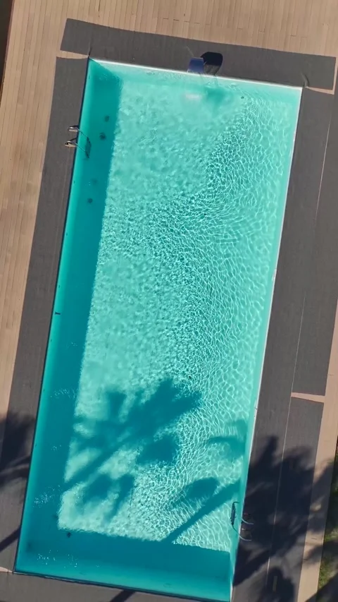 Vertical Video of a Beautiful Pool in a Residential Area With Green Spaces and 動画素材 300343503