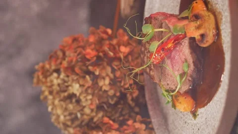 Vertical video. A beautiful portion of steak, with a beautiful decor. Stock Footage 153240534