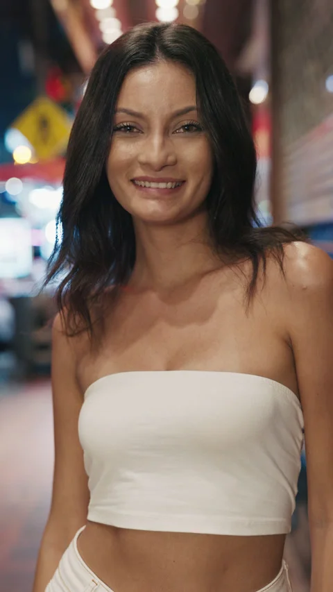 Vertical Video. Beautiful Positive Lady Standing in Chinatown in the Evening and Stock Footage 281002608