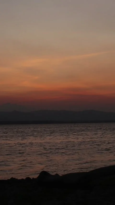 Vertical video of a Beautiful view of the sunset on a summer day. lake sunset Video stock 260364939