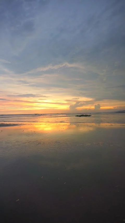 Vertical video of beautiful views of the sunset on the beach with small waves Stock Footage 263581220