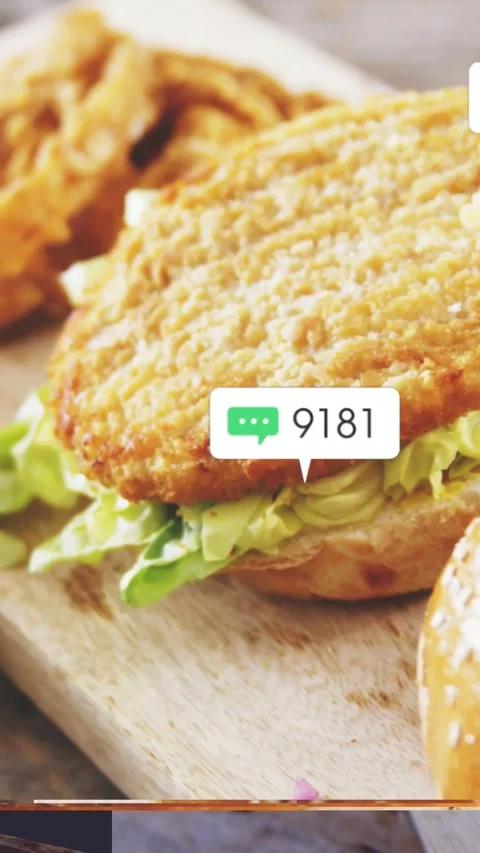 Vertical video: Bell dinging starting chicken sandwich reveal, icons rising, Stock Footage 328398664