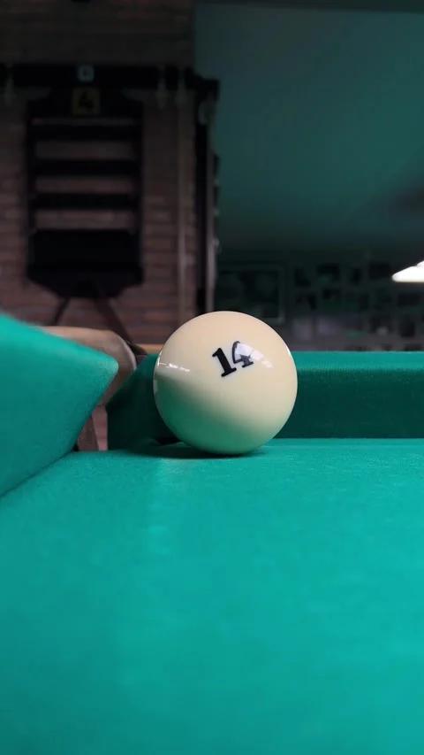 Vertical video. Billiard ball with red dot pockets white ball with number 14 Stock Footage 269740877