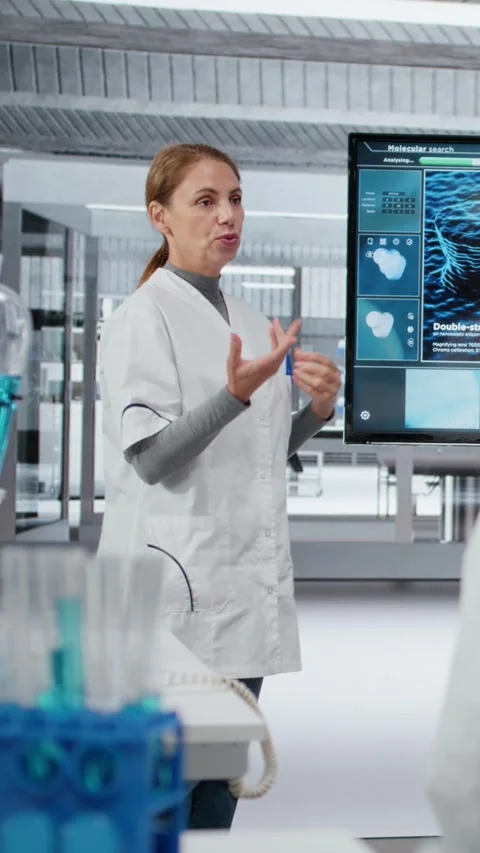 Vertical video Biotechnology expert in lab presenting innovative DNA sequencing Stock Footage 325916158