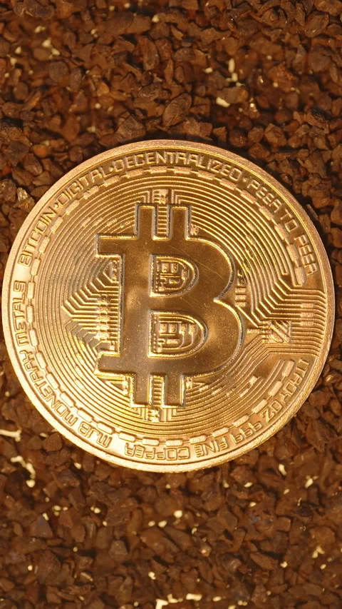 Vertical video. A Bitcoin Coin Resting on Gravel With a More Diffused Golden Video stock 296481191