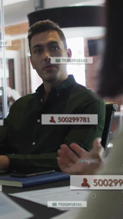Vertical video: Biz pro looking up when speaker gestures listening while AR IDs Stock Footage 334386338
