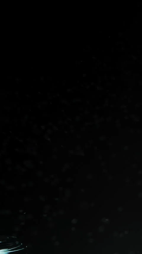 Vertical video. On a Black Background, Perfume Is Sprayed, Slow Motion, Isolated Vidéo 268727386