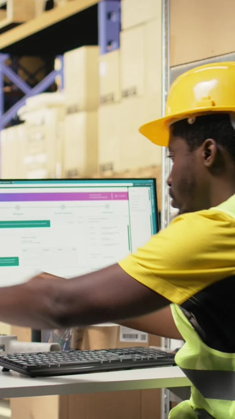 Vertical Video Black depot clerk reviewing inventory data on tracking software Stock Footage 315190845