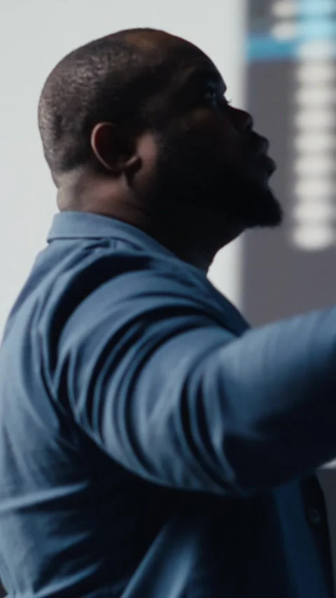 Vertical Video Black engineer explores algorithm design and binary code with AI Stock Footage 312179556