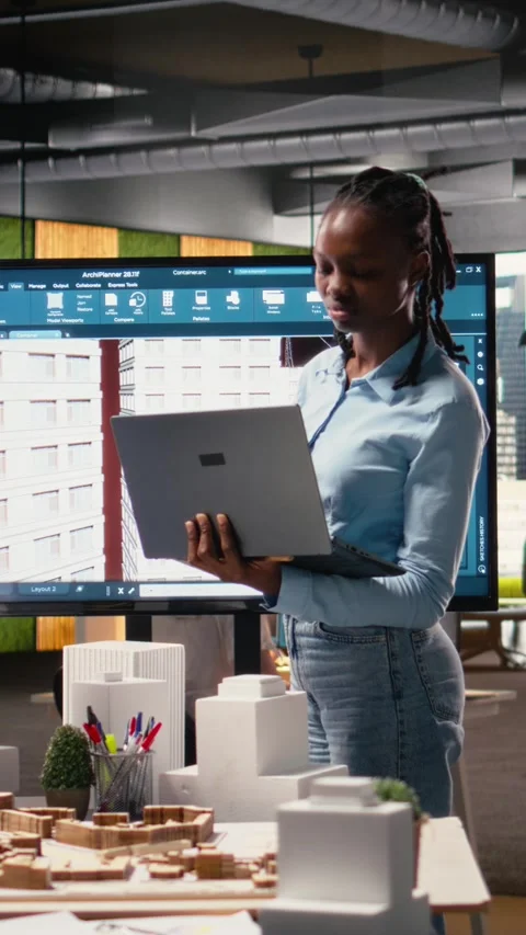 Vertical Video Black female developer reviewing zoning regulations with 3D Stock Footage 316339092
