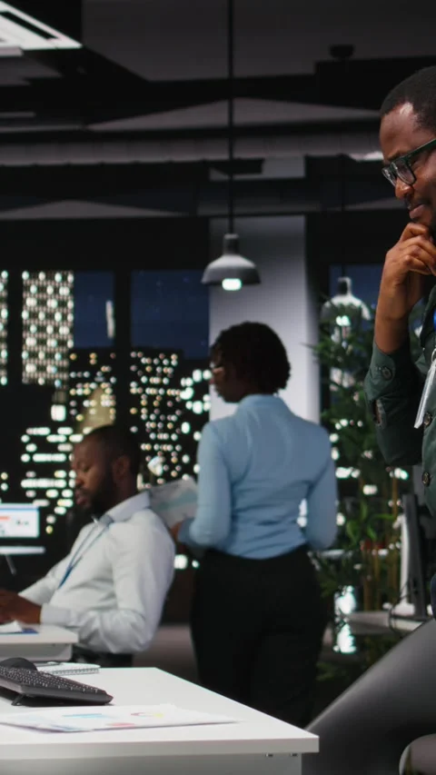 Vertical Video Black general manager thinking about a complex problem in a dark Stock Footage 318625090