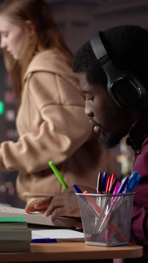 Vertical Video Black guy using study music to help with deep focus for academic Stock Footage 307242545