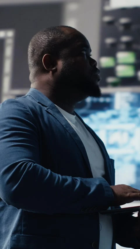 Vertical Video Black IT engineer working in a digital environment with Stock Footage 312177519