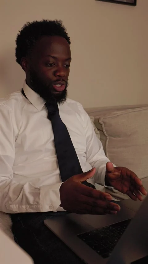 Vertical Video Of Black Male Worker In Heated Debate Over Video Call At Home Stock Footage 319994944