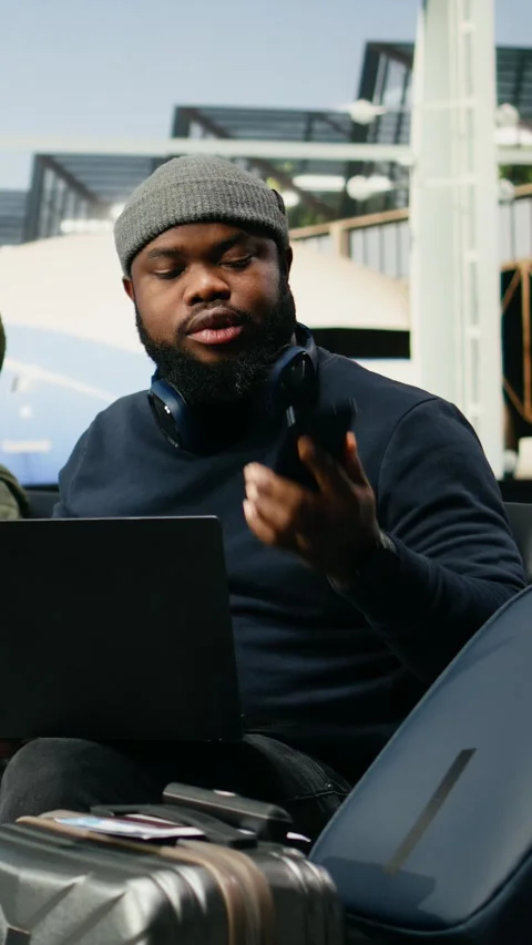 Vertical Video Black man in crisis mode talking on phone call to solve startup Stock Footage 339666138