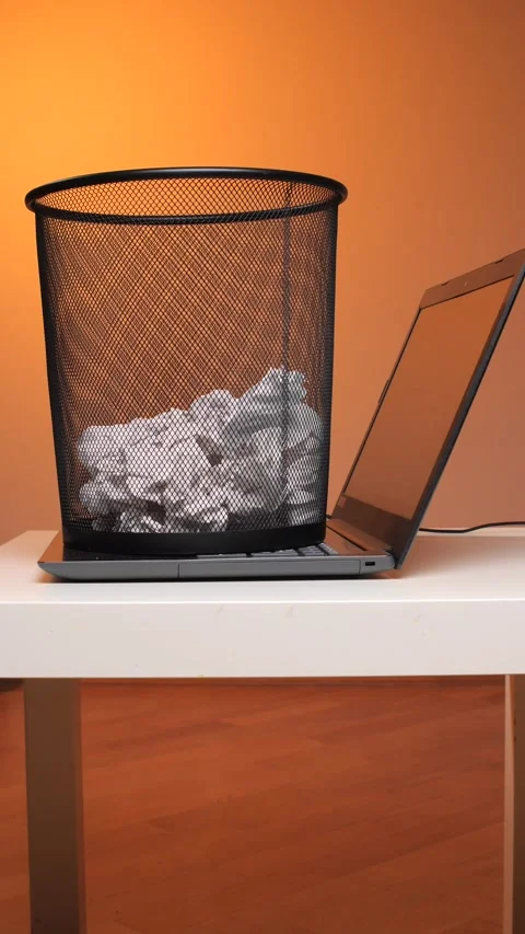 Vertical video a black mesh trash bin, overflowing with crumpled white paper Stock Footage 347240409