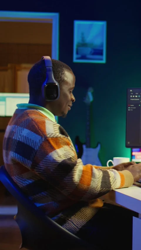 Vertical Video Black programmer remotely working in home office writing code on Video stock 319520076