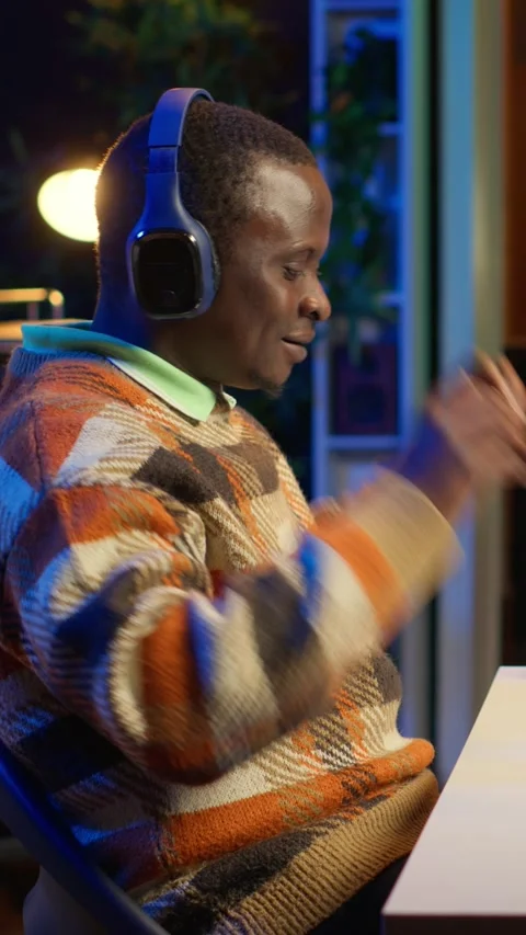 Vertical Video Black programmer remotely working in home office writing code on Stock Footage 319539200