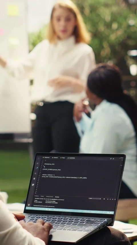 Vertical Video Black software developer working on programming code on laptop Stock Footage 339070068