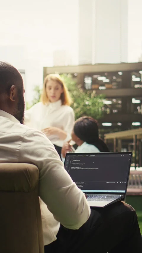 Vertical Video Black software developer working on programming code on laptop Stock Footage 339070768
