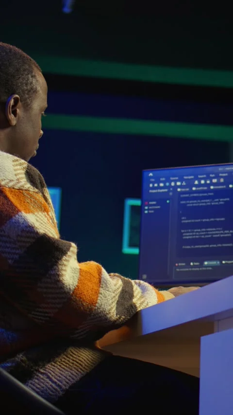 Vertical Video Black software engineer writes complex binary code scripts on Stock Footage 319565814