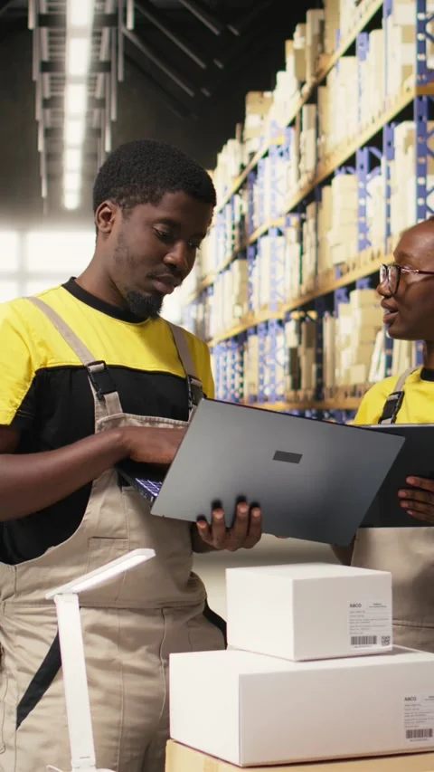 Vertical Video Black team members handling package data on laptop for order Vidéo 315190070