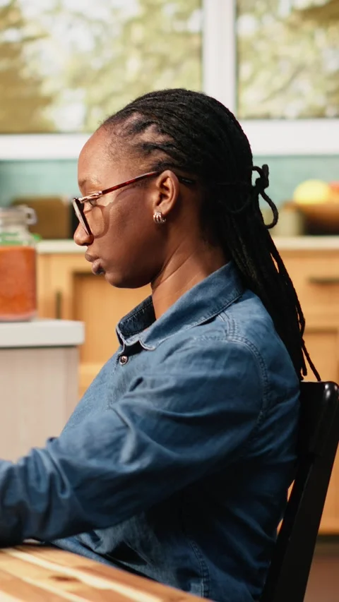 Vertical Video Black woman programming on laptop in kitchen representing hybrid Vídeo Stock 344530931