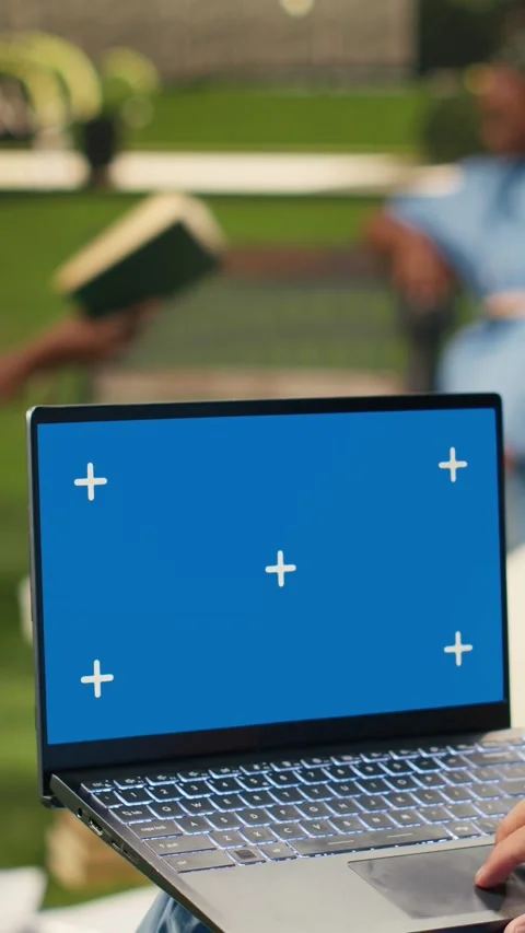 Vertical Video Blue screen chroma key on laptop held by black medical student Stock Footage 341321139