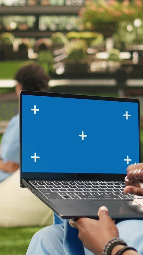 Vertical Video Blue screen chroma key on laptop held by black medical student Stock Footage 341321416