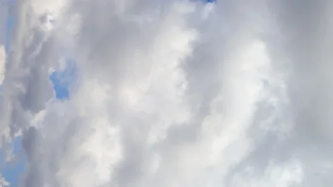 Vertical video. Blue sky with white fluffy cumulus clouds. Stock Footage 238074477