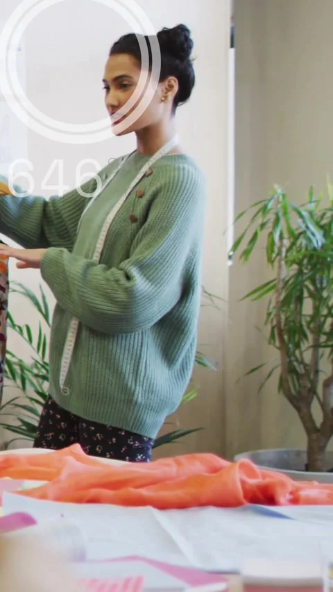 Vertical video: Blurred head shifting aside tailor checking garment fit with HUD Stock Footage 334317609