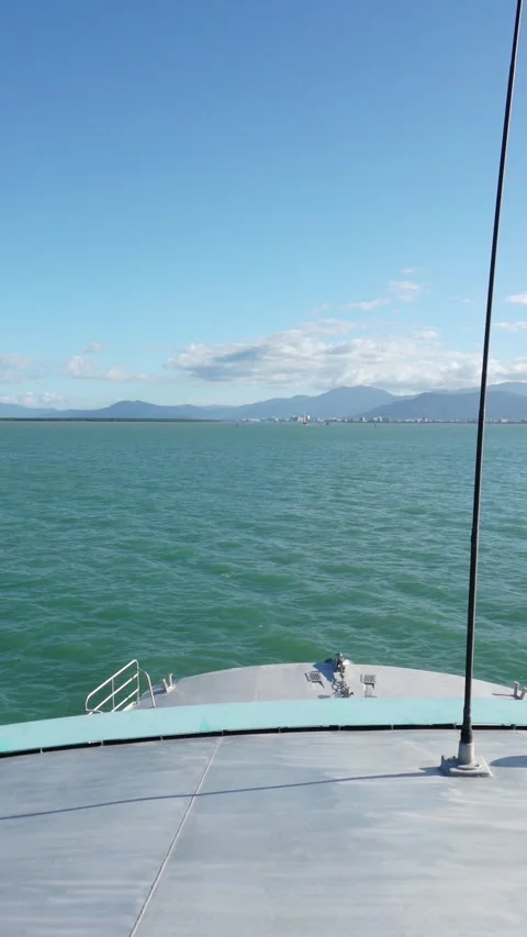 Vertical video of Boat approaching tropical island jetty in australia in the Stock-Footage 330942452