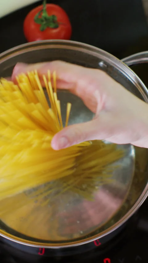 Vertical video. Boil the boiled pasta in a saucepan bowl. Stock Footage 345060019