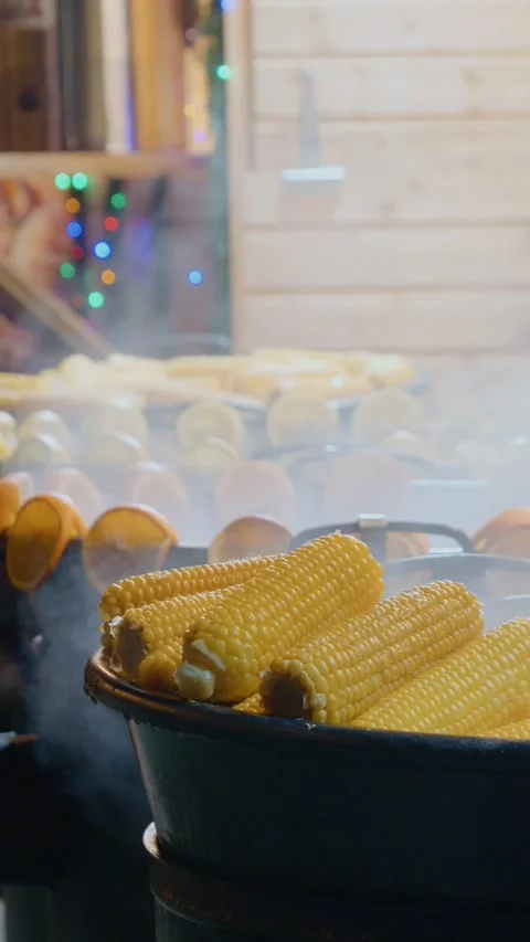 Vertical video Boiled corn served at a Christmas market during the holiday Stock-Footage 347196469