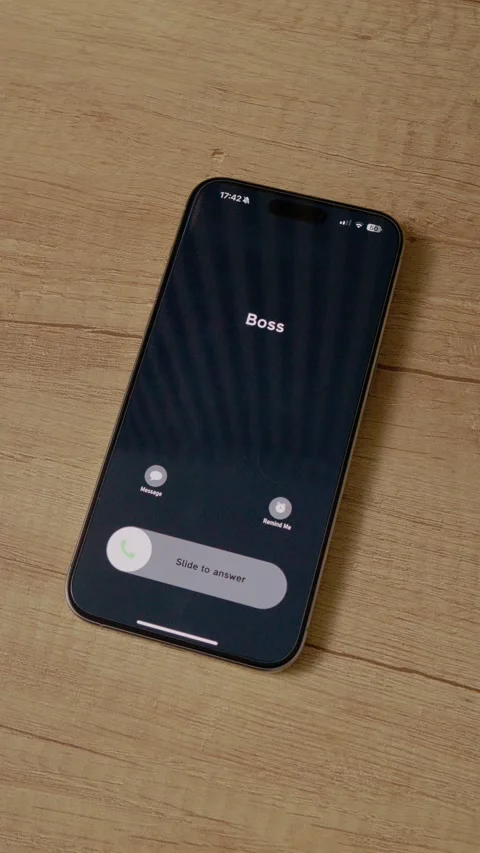 Vertical video Boss calls on smartphone while resting on wooden table during Stock Footage 346715953