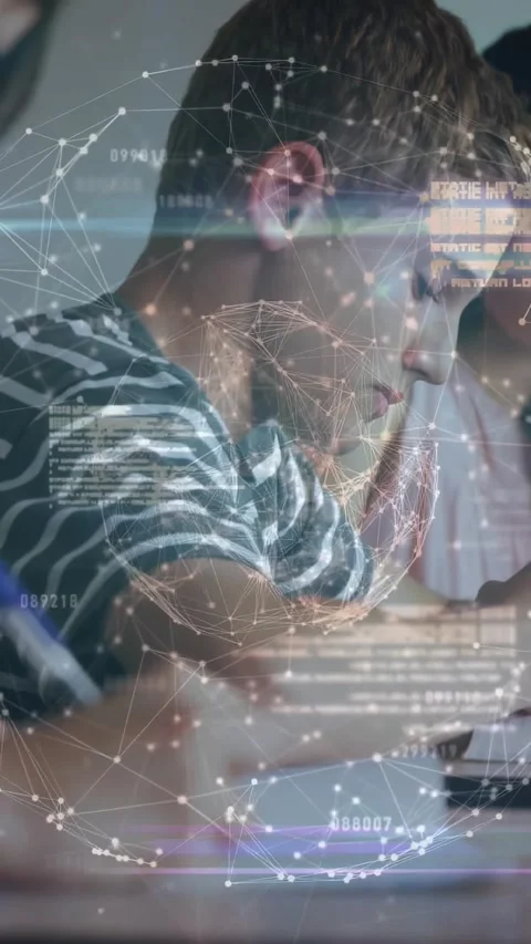 Vertical video: Boy bringing pen down, writing notes in class as network globe Stock Footage 329840581