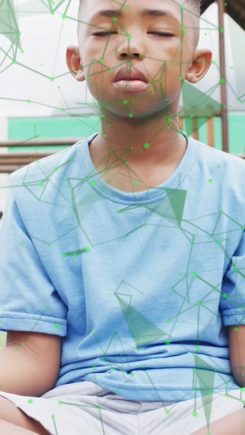 Vertical video: Boy on mat eyes closed, camera rising to center face, overlay Stock Footage 334704923