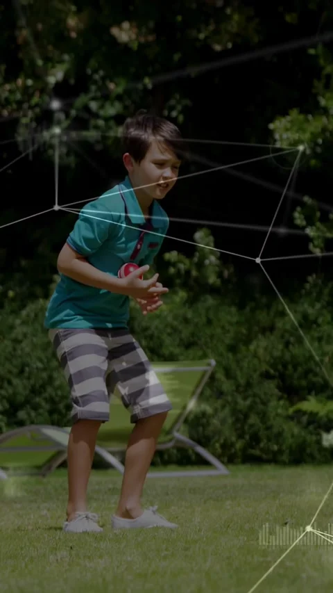 Vertical video: Boy squatting catching incoming red ball rising left with tech Stock Footage 332317809