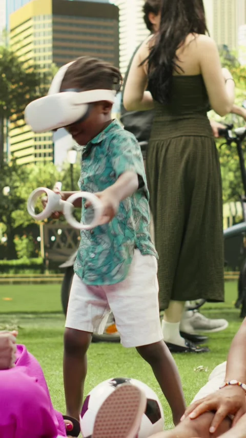 Vertical Video Boy wearing virtual reality glasses and holding motion Stock Footage 341470994