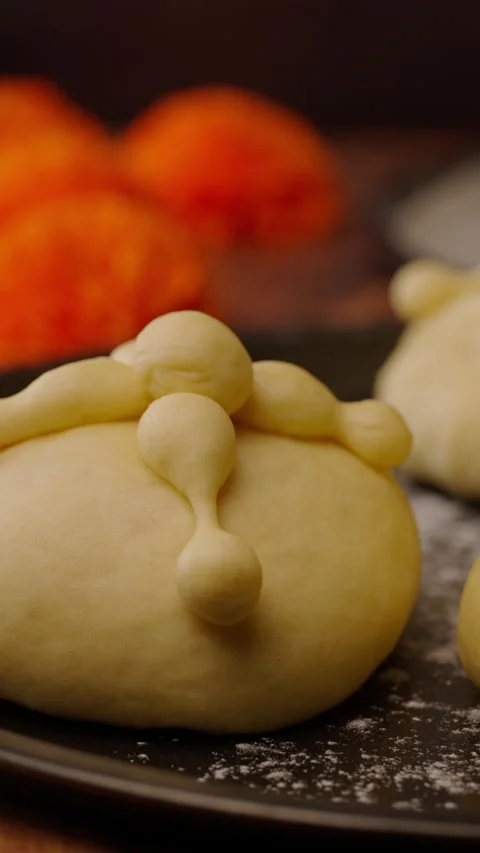 Vertical video, bread of the dead before putting it in the oven and a marigogold Stock Footage 282499592