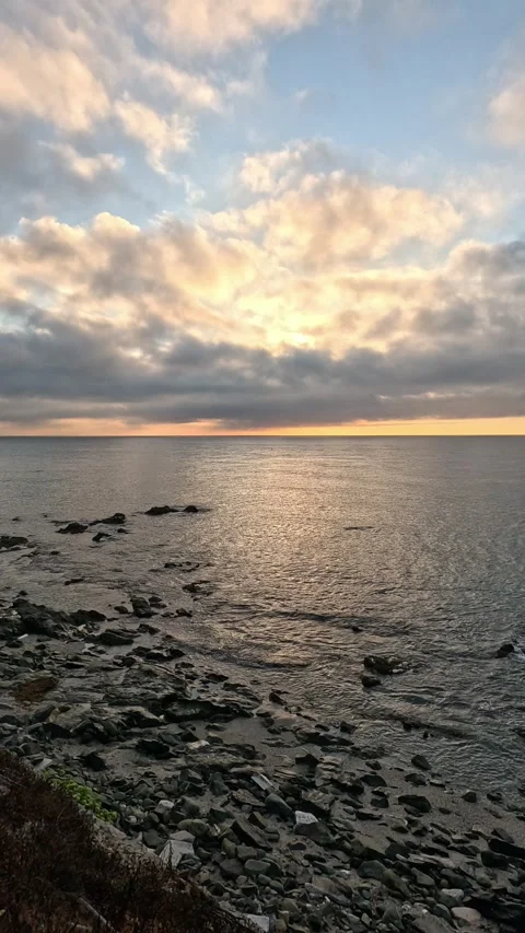 Vertical video of breathtaking dawn between clouds over the sea Stock Footage 296489067