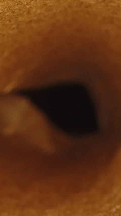 Vertical video. Brown baking paper rolled into a tube. Dolly slider extreme clos Stock Footage 247955676