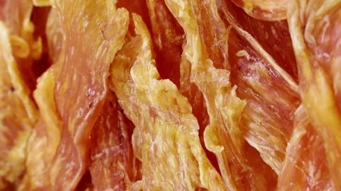 Vertical video, brown dried chicken breast jerky meat circle rotation close up Stock Footage 246540305