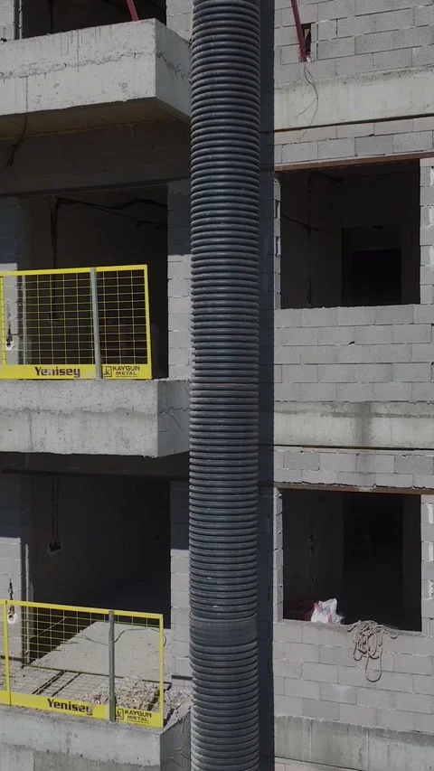 Vertical Video Builder on Rooftop Construction Site with Steel Reinforcement and Stock Footage 342470247