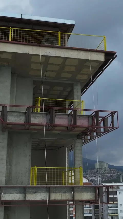 Vertical Video: Building Under Construction Near the Coast With a Beautiful Blue Stock Footage 342587816