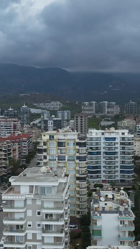 Vertical Video: Building Under Construction Near the Beach With Cranes and a Stock Footage 342588780