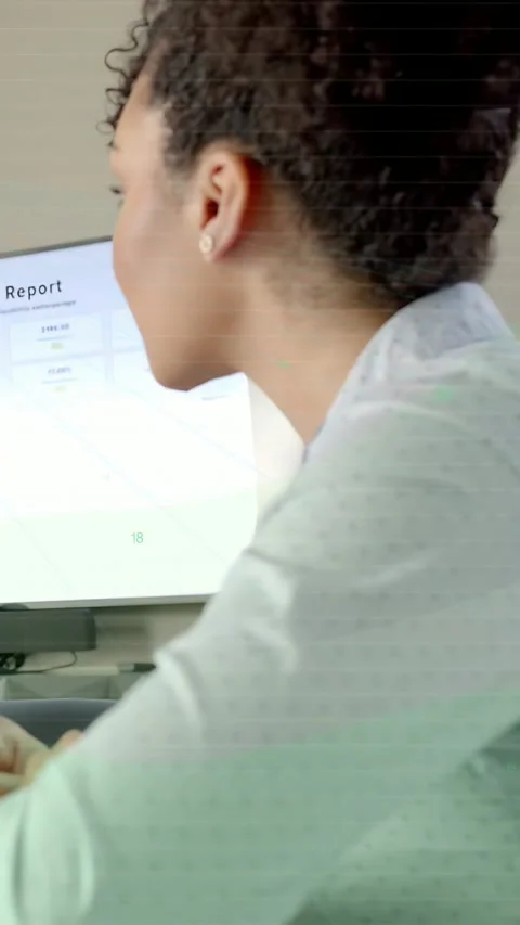 Vertical video: Business analyst leaning, typing at desk as monitor updating Stock Footage 337540501