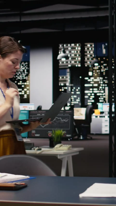 Vertical Video Business manager using laptop, standing in office, evaluate Stock Footage 334103591